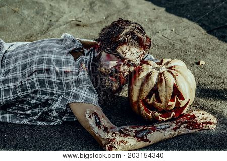 Halloween Zombie Hipster With Red Blood On Paving Asphalt