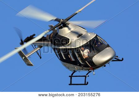 Zhukovsky, Moscow Region, Russia - August 21, 2015: Kazan Ansat 909 BLACK perfoming demonstration flight in Zhukovsky during MAKS-2015 airshow.