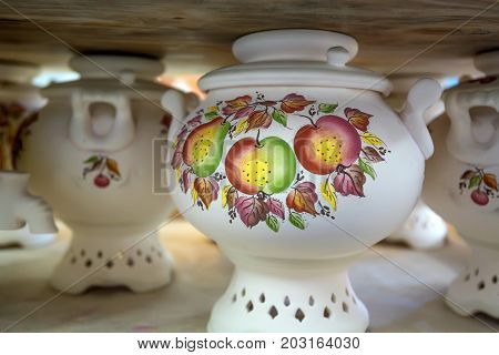 Close up delft samovars traditional russian teapots with floral traditional ornament painting