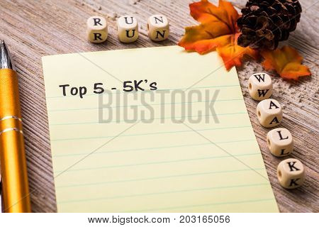 Top 5 - 5K's run walk concept on notebook and wooden board