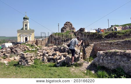 Khotyn - Chernivtsi - Ukraine - May 1 2012. The foundation of the remnants of the old building and the church in the background on the territory of medieval fortress Khotyn