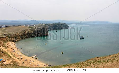 sandy beach by the lake with lots of holidaymakers