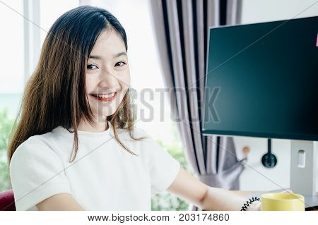 Young asian girl is freelancer with her private business at home office working with laptop coffee online marketing Customer order and packaging or packing.