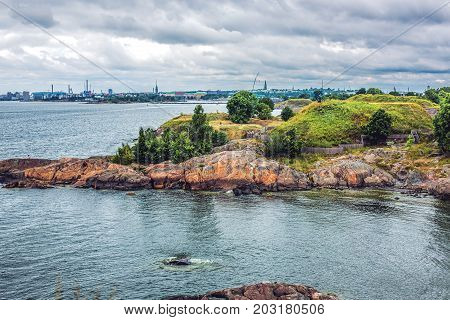 View of a bay and a beach in Suomenlinna Island with bathers in Helsinki Finland