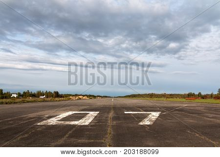 Plane runway airstrip in the airport terminal with marking on blue sky with clouds to use as background. Travel aviation and holiday concept. Soft focus