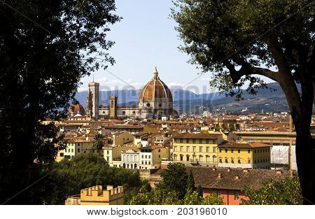 View on the Cathedral di Santa Maria del Fiore (Duomo di Firenze) between two trees Florence Italy