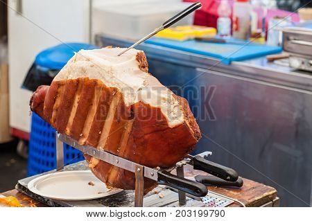 Close up of italian cooked ham ready to be sliced .