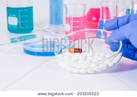 Scientist analyzing pills in medical laboratory. Analysis of medicaments in laboratory. Medical Research and diseases Science.