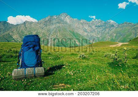 Hiking backpack with foambackground of the Caucasus mountains sunny weather