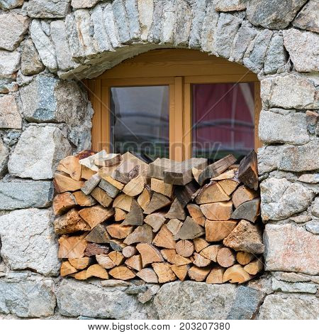 Firewood Logpile Stacked In A Window