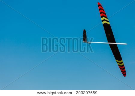RC remotely controlled soaring plane model sailplane on blue sky in brisk wind