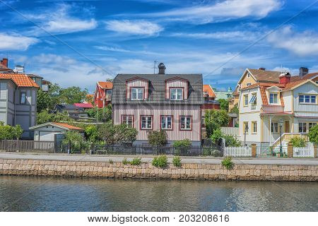 KARLSKRONA SWEDEN - 2017 July. Typical red Swedish wooden houses with natiaonal flag in the city of Karlskrona.