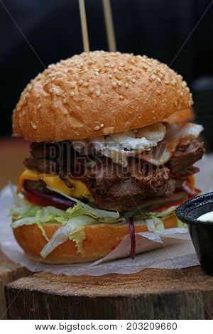 Big Burger With Pulled Pork Meat On Wooden Cut