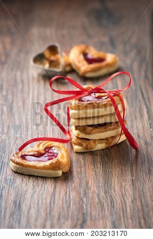 Fresh cookies with a bow on a wooden table. Use it for a card or recipe.