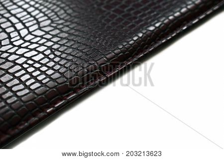 a piece of dark skin on a white background. Texture