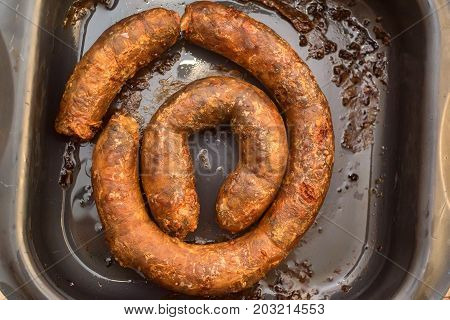 Close up delicious fried pork sausage on frying pan