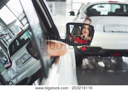 woman in car indoor keeps wheel turning around smiling looking at passengers in back seat idea taxi driver against sunset rays Light shine sky Concept of exam Vehicle - second home the girl.