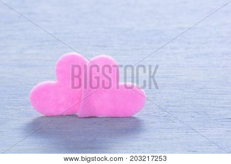 Valentine Decoraton with two pink hearts on a wooden Background. Love concept.