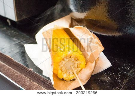 boiled corn with salt on the table closeup
