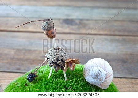 Funny creature made of acorn and pine cone. Craft for children.