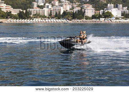 BUDVA, MONTENEGRO - AUGUST 07, 2017:Skating by the sea on a water scooter.