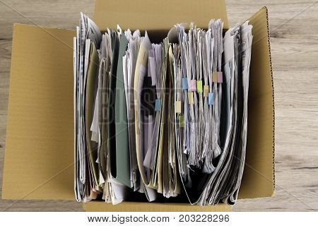Documents File in the Brown box on wood desk