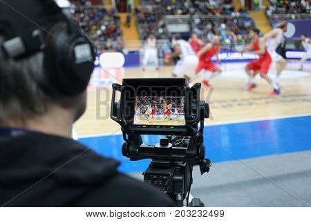 MOSCOW - JAN 27, 2017: Cameraman (out of focus) and camera display at basketball match CSKA (Moscow) - Anadolu Efes (Istanbul) in Megasport stadium