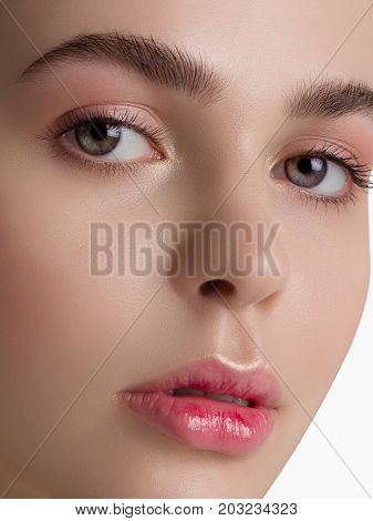 Macro sensual portrait of the woman with a day make-up and pure leather. Sensual full lips and equal eyebrows. Care of skin Spa cosmetology correction of eyebrows