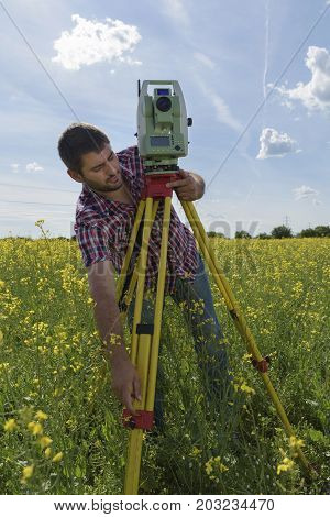 Young Man Surveyor Rapeseed Geodesy Field Work