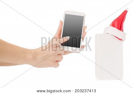 Female hand holding a mobile phone smartphone box Santa hat frost gift on a white background isilation