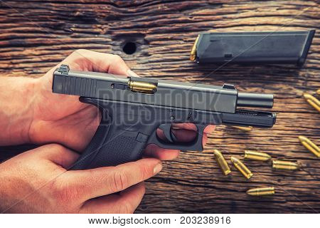Charging gun. Man hands charging 9mm pistol gun.