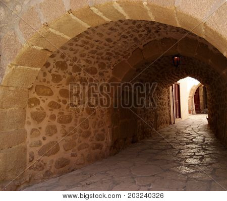 Semi-dark passage with a stone arched vault in the monastery of St. Catherine Sinai (one of the oldest working Christian monasteries in the world) without people.