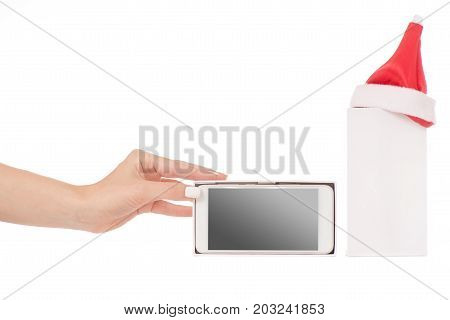 Female hand holding a mobile phone smartphone box Santa hat frost gift on a white background isilation