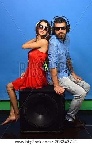Guy With Beard And Lady With Serious Faces Enjoy Music