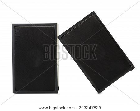 A close-up picture of two big black vintage loudspeakers leaning on each other isolated on a white background. Audio equipment for sound quality. Entertainment, technology, music concept.