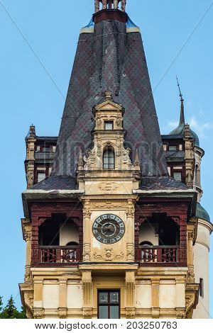Sinaia Romania - june 21 2017: Close-up view on tower with clock of Peles castle at Sinaia town in Romania summer residence of Romanian royal family.