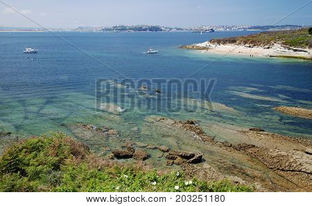 Bay of Satander Cantabria Spain View from the edge of Playa de Loredo towards small island La Isla de Santa Marina