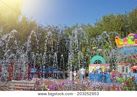 The fountain in the park splashing the stream of water pouring from the fountain the spray of the fountain in summer park sunny day in the city park