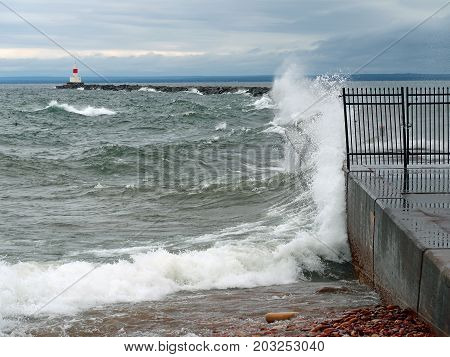Waves of Lake Superior splash against the Presque Isle breakwater which protects the harbor at Marquette Michigan.