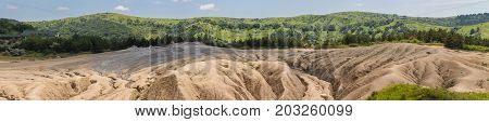 Landscape of mud volcanoes at Berca in Romania panoramic view.