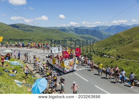 Col de PeyresourdeFrance- July 23 2014: Cofidis vehicle passing in the Publicity Caravn on the road to Col de Peyresourde in Pyrenees Mountains during the stage 17 of Le Tour de France 2014.