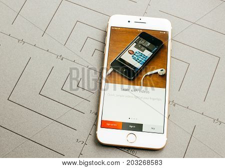 PARIS FRANCE - SEP 26 2016: Male hand holding New Apple iPhone 7 Plus after unboxing and testing by installing the app application software Adobe software app sign-in
