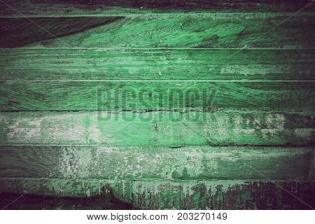 Green vintage wood texture and background. Close up view of green vintage wood texture and background. Abstract background and texture for designers. Rustic table. Texture of handmade green table.