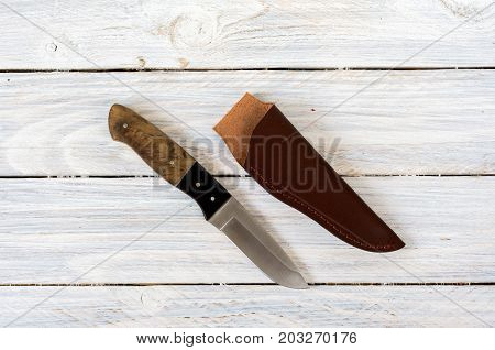 Knife With A Fixed Blade In The Center Of The Composition.