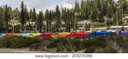 A line of trucks that are all of a different color.