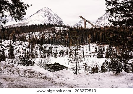 Solisko peak with springboard for ski jumping Strbske pleso Slovak republic. Retro photo filter. Winter mountains.