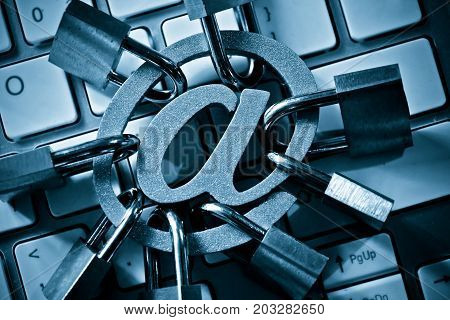 Email sign with many padlocks on computer keyboard / Email encryption security and countermeasure concept