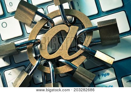 Email sign with many padlocks on computer keyboard / Email encryption security and countermeasure concept