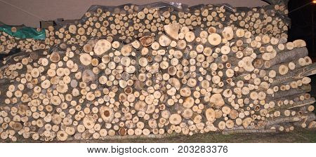 Pile of wood prepared for winter at dark
