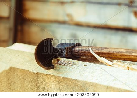 Rusty tip of sharp ax lies on edging boards
